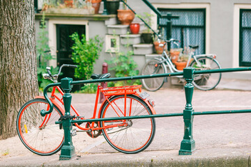 Fototapeta premium Bikes on the bridge in Amsterdam, Netherlands. Beautiful view of canals in autumn