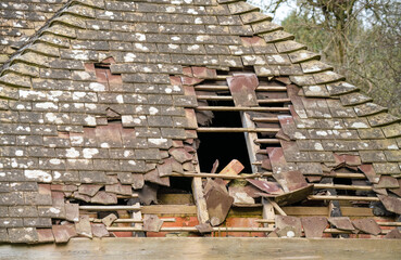 an old tiled roof damaged by recent storm weather
