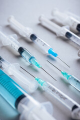 Medicine. A bunch of different syringes over a white background