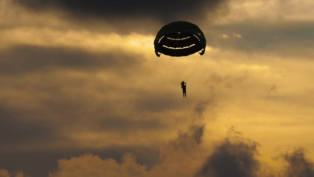 Parachute flight at sunset