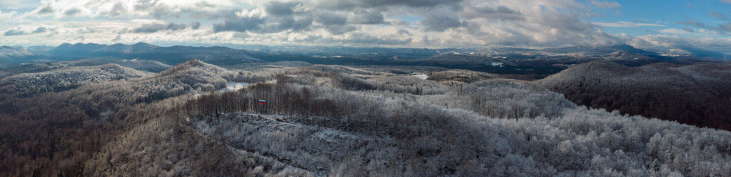 Wide panorama looking from Ostri vrh towards beautiful Radensko polje close to Grosuplje, Slovenia. Snow on the top, while green meadows at the bottom.
