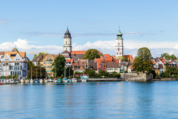 Fototapeta na wymiar Lindau, Germany. Scenic view of the embankment with the bell towers of medieval cathedrals