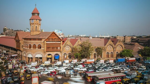 Time lapse view of rush hour traffic outside historic landmark Crawford Market in Mumbai, Maharashtra, India, zoom out.