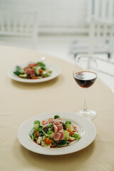nicoise salad with a glass of red wine