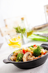 vegetarian stir fry in black pan, vegan food