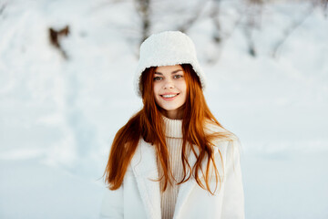 woman in a white coat in a hat winter landscape walk Lifestyle