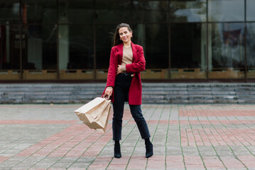 Happy woman with shopping bags enjoying shopping. Consumerism, lifestyle concept