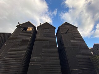 Traditional fishing boat and huts of fishermen, Hastings old town, East sussex, uk