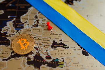 Ukrainian flag on the background of the map of Europe and bitcoin