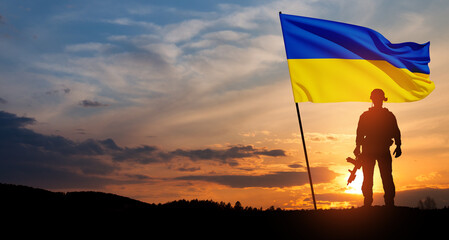 Flag of Ukraine with silhouette of soldier against the sunrise or sunset. Concept - armed forces of Ukraine. Relationship between Ukraine and Russia.