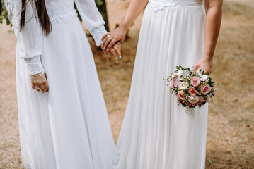 Lesbian brides holding wedding bouquets