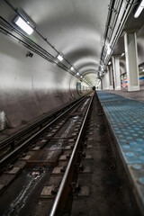 Fototapeta premium Empty underground commuter subway tunnel tracks