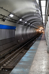 Empty underground commuter subway tunnel tracks