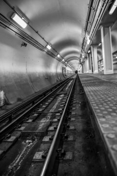 Empty underground commuter subway tunnel tracks