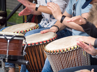 Close up view to the palm of hand playing on an African djembe.