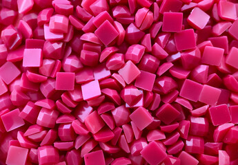 Close-up, pink square diamonds for diamond embroidery. Hobbies and DIY, materials for creating diamond embroidery