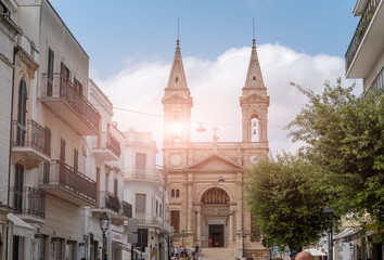 Naklejka premium Alberobello, Puglia, Italy. August 2021. Amazing view of the cathedral Basilica of Saints Cosmas and Damian (Parrocchia Santuario Basilica S.S. Cosma E Damiano)