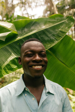 Smiling portrait of a black african male farmer in the rainforest