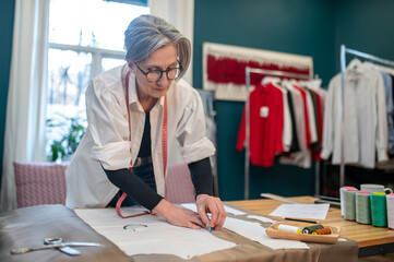 Woman touching cloth on table with chalk