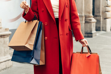 Sale season women's hands hold many shopping bags	
