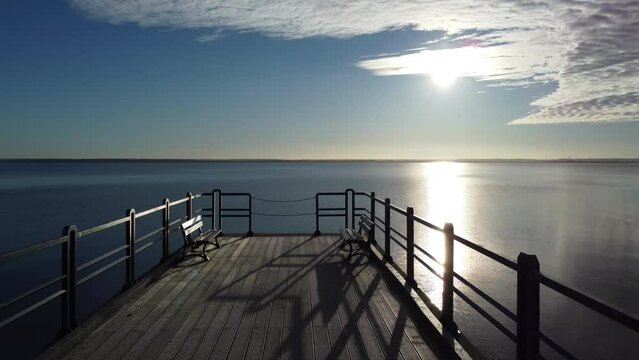 Sunset on the pier. The town of Chałupy. Hel Peninsula. Poland. 
