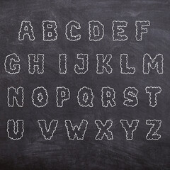 Alphabet on blackboard school classroom chalk letters english  - obrazy, fototapety, plakaty