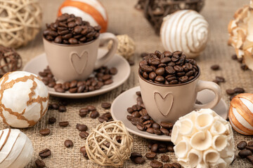 Cup full of coffee on burlap, 
scattered coffee on burlap.  