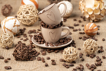 Cup full of coffee on burlap, 
scattered coffee on burlap.  