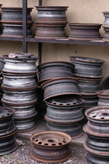 Old rusty metal car rims folded in a garage