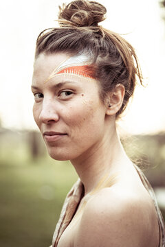 alternative young strong woman with tribal face paint