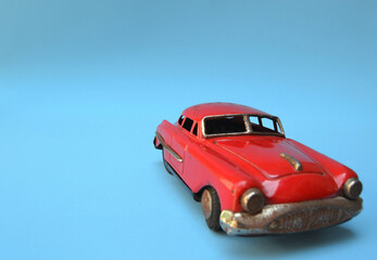 Fototapeta na wymiar Vintage toy car on a blue background