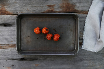 Oven roasted deli tomato on the vine on rustic oven tray 