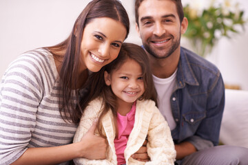 Fototapeta premium Theres an abundance of love in this home. Portrait of a happy young family sitting together at home.