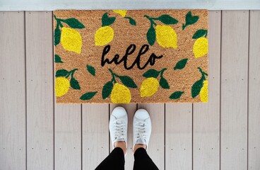 Looking down at a welcome mat - obrazy, fototapety, plakaty