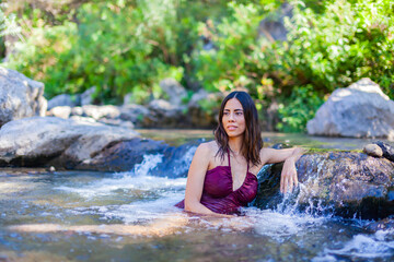 Beautiful exotic woman in a river