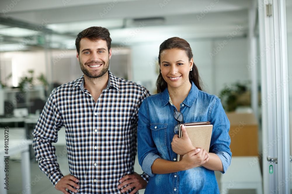 Canvas Prints We make a great team. Portrait of two colleagues standing in the office.