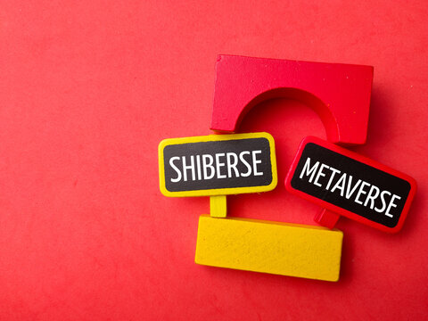 Top view colored block and wooden board with text SHIBERSE METAVERSE on red background.