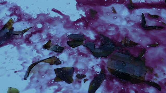 Red Wine Bottle Smashes On Ground In The Evening