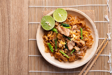 Thai food (Pad See Ew), Stir fried rice noodles with soy sauce, egg, kale and pork, Table top view
