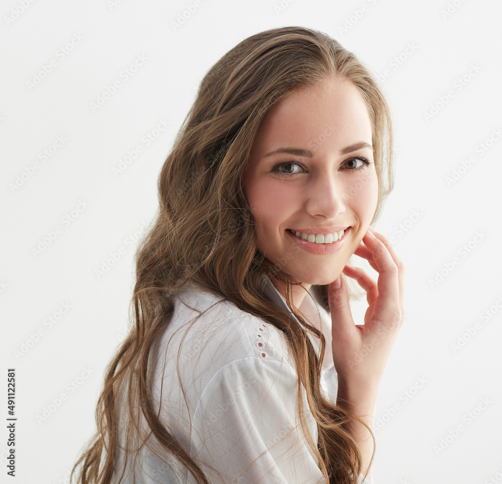 Canvas Prints Just a little look back.... Studio shot of a young woman looking over her shoulder at the camera.