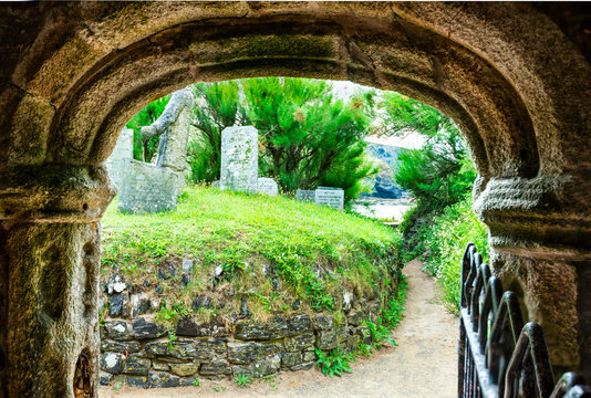 Ancient stone,arched entrance to Saint Winwaloe's Church,Cornwall,Gunwalloe,southwest England,UK.
