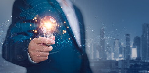 Businessmen hand holding creative light bulb with network connection line on planning strategy, analysis solution and development, Modern business, Innovative of new ideas.