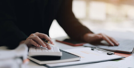Close up view of bookkeeper or financial inspector hands making report, calculating or checking...