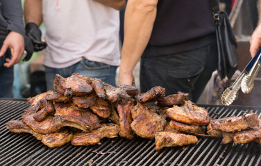 Roasting meat on the grill. Cooking fast food on the street.