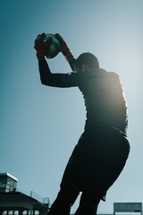 goalkeeper silhouette catching the ball