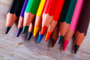 Fototapeta premium Picture of multicolored pencils on wooden background
