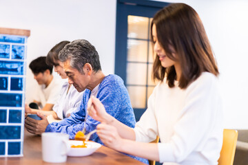 Obraz premium レストランのカウンター席でご飯を食べる人々