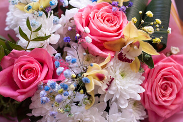 Beautiful festive bouquet of flowers. Bouquet with pink lush roses for the holiday and greeting card. High quality photo