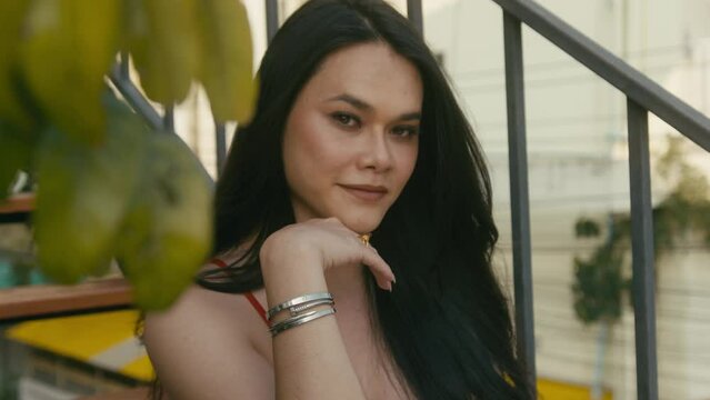 a beautiful trans woman looks at camera