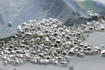 Money in the form of a cash banknote and precious metal, precisely sterling silver which is important in stocks, jewelry and industrial use and gets expensive during crisis. 